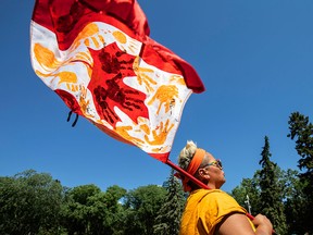 A woman takes part in a march held in memory of the children who attended Indigenous residential schools, on Canada Day in Edmonton, July 1, 2021.