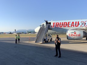 Liberal Leader Justin Trudeau makes it a point to wave from the top of the airstairs at every new campaign stop—even when there's nobody around. The National Post's John Ivison captured this image in Vancouver, noting "there’s no one here but staff and reporters, and he’s definitely not waving at us."