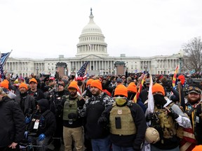 Members of the far-right group Proud Boys make 'OK' hand gestures indicating "white power" as supporters of former U.S. President Donald Trump gather in front of the Capitol Building to protest against the certification of the 2020 U.S. presidential election results by Congress, in Washington, on Jan. 6, 2021.
