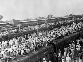 Railway wagons packed with Muslim refugees flee to Pakistan, as Hindus flee to India by train, in the border city of Amritsar between the two countries at the start of the first war between India and Pakistan in 1947.