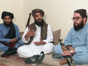 Waheedullah Hashimi (centre), a senior Taliban commander, gestures as he speaks with Reuters during an interview at an undisclosed location near Afghanistan-Pakistan border Aug. 17, 2021.