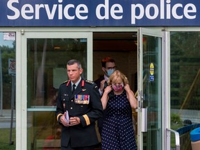 Major General Dany Fortin exits the Gatineau Police headquarters with his lawyer Phillipe Morneau and his wife Madeleine Collin on Wednesday August 18,2021.