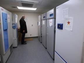 Brian Pallister, Premier of Manitoba, looks at the special -80 degree freezers at the COVID-19 vaccination clinic at the Health Sciences Centre in Winnipeg, Monday, December 14, 2020.