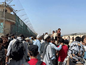 Crowds of people gather outside the airport in Kabul, Afghanistan August 23, 2021.