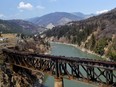 The charred remnants of the rail bridge, destroyed by a wildfire on June 30, is seen during a media tour by authorities in Lytton, B.C., July 9, 2021.