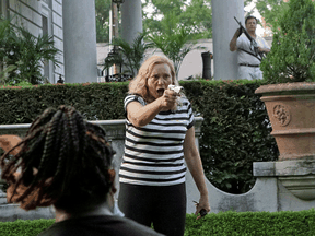 Patricia McCloskey and her husband Mark McCloskey draw their firearms on protesters as an anti-racism rally enters their neighborhood, in St. Louis, Missouri, June 28, 2020.