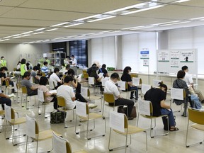 Residents wait in an observation area after receiving the Moderna Inc. Covid-19 vaccine at a mass vaccination site in Saitama City, Saitama, Japan, on Monday, Aug. 23, 2021.