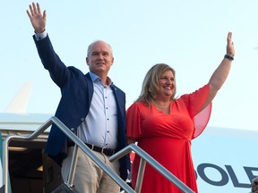 Conservative Leader Erin O'Toole and his wife, Rebecca, board their campaign plane in Ottawa on Aug. 25, 2021, for a flight to Hamilton, Ont.
