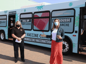 Health officials stand in front of a mobile COVID vaccination clinic that was launched in Sudbury on July 12, 2021.