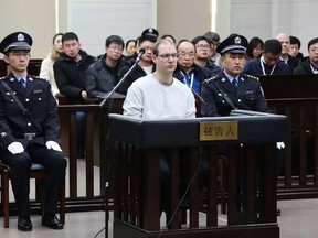 This handout photograph taken and released by the Intermediate Peoples' Court of Dalian on January 14, 2019 shows Canadian Robert Lloyd Schellenberg (C) during his retrial on drug trafficking charges in the court in Dalian in China's northeast Liaoning province.