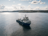 A ship sails along a coast line as it lays undersea fiber optic communications cable near the village of Teriberka, on the Barents Sea, Russia, August 6, 2021.