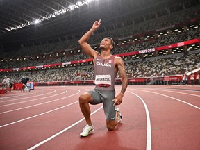 Andre De Grasse, of Canada, celebrates after winning the final of the men's 200-meters at the 2020 Summer Olympics in Tokyo, Japan, Wednesday, Aug. 4, 2021.
