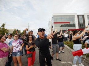 Demonstrators cheer after it's announced that an outdoor rally planned for Justin Trudeau, Canada's prime minister, is cancelled, in Bolton, Ontario, Canada, on Friday, Aug. 27, 2021.
