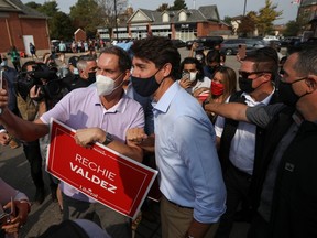 Justin Trudeau poses for a selfie with a supporter during his election campaign tour in Mississauga, Ontario, on August 27, 2021.