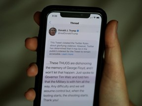 In this photo illustration a notification from Twitter appears on tweet by U.S. President Donald Trump that the social media platform says violated its policy on May 29, 2020 in San Anselmo, California.