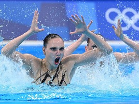 Russia's Svetlana Kolesnichenko and Russia's Svetlana Romashina compete in the preliminary for the women's duet free artistic swimming event during the Tokyo 2020 Olympic Games.