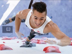 In this overview picture Canada's Sean Mccoll competes in the men's sport climbing speed qualification during the Tokyo 2020 Olympic Games.