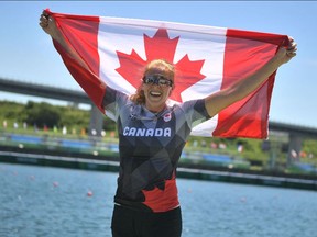 Silver medallist Canada's Laurence Vincent-Lapointe celebrates with a flag after the women's canoe single 200m final during the Tokyo 2020 Olympic Games at Sea Forest Waterway in Tokyo on August 5, 2021.