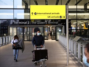 Travellers walk through Terminal 2 at Heathrow Airport, amid the coronavirus disease (COVID-19) outbreak in London, Britain February 14, 2021.