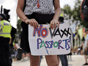 A woman protests against vaccine passports in London, England, on July 19, 2021.