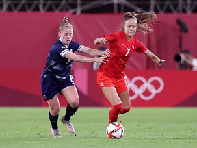 Tokyo 2020 Olympics - Soccer Football - Women - Group E - Canada v Great Britain - Ibaraki Kashima Stadium, Ibaraki, Japan - July 27, 2021. Julia Grosso of Canada in action with Kim Little of Britain