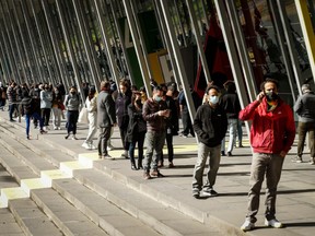 A large number of people are seen lining up outside the Melbourne Exhibition Centre Vaccine Hub on August 25, 2021 in Melbourne, Australia.