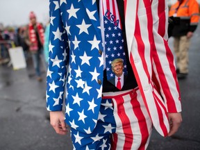A man wearing a patriotic suit and Donald Trump themed tie joins supporters queueing before President Donald Trump holds a rally on October 26, 2020 in Lititz, Pennsylvania.