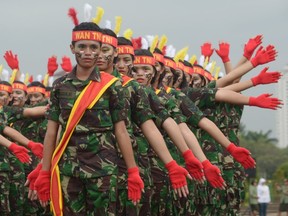 Female members of the Indonesian armed forces perform as they mark Kartini Day in Jakarta on April 22, 2013.