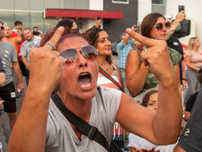 Protestors react while awaiting an election campaign visit by Canada's Liberal Prime Minister Justin Trudeau, which was cancelled citing security concerns, in Bolton, Ontario, Canada August 27, 2021.