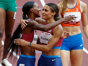 Dalilah Muhammad of the United States and Sydney McLaughlin of the United States embrace after competing.