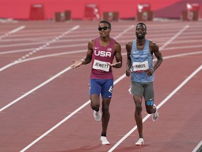Isaiah Jewett of Team USA and Nijel Amos of Team Botswana jog to the finish after falling in their semifinal heat of the men's 800 meters. MUST CREDIT: Washington Post photo by Toni L. Sandys.
