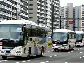 Designated buses travel near the Olympic Village in Chuo Ward, Tokyo, on Thursday. MUST CREDIT: Japan News-Yomiuri photo