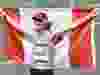 Tokyo 2020 Olympics – Athletics – Men’s 50km Walk – Sapporo Odori Park, Sapporo, Japan – August 6, 2021. Evan Dunfee of Canada celebrates with his national flag after winning bronze REUTERS/Feline Lim