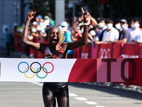 Peres Jepchirchir of Kenya celebrates as she wins gold in the Tokyo 2020 Olympic marathon.