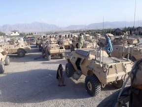 Taliban fighters with captured M117 vehicles at Kabul airport.