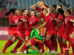 Canada's players celebrate winning 4-3 in a penalty shootout against Brazil during a women's quarterfinal soccer match at the 2020 Summer Olympics, Friday, July 30, 2021, in Rifu, Japan.