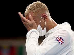 Arlen Lopez Cardona of Cuba and Benjamin Whittaker of Britain react after their final fight.