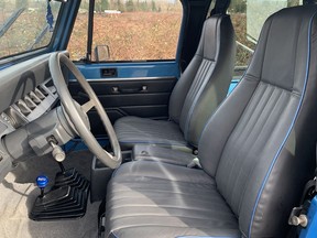 The seats were reupholstered in gunmetal grey leather with blue piping to match the exterior colour.