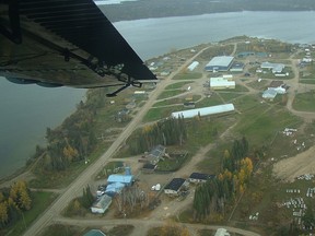 A plane flies over the community formerly known as Big Trout Lake, Ont.
