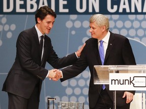 File: Conservative Leader Stephen Harper, right, and Liberal Leader Justin Trudeau shake hands after participating in the Munk Debate on Canada's foreign policy in Toronto, on Monday, Sept. 28, 2015. THE CANADIAN PRESS/POOL-Mark Blinch