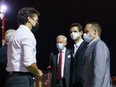 Michael Kovrig and Michael Spavor are greeted by Prime Minister Justin Trudeau after landing in Calgary, following nearly three years of detention in China, on Sept. 25.