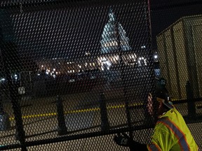 Workers install security fencing around the U.S. Capitol in preparation for this weekend's Justice for J6 Rally on Sept. 15, 2021.