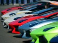 A man looks at Lamborghini sports cars parked in front of Milan's Sforza castle in 2013.