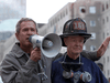 U.S. President George W. Bush, standing next to retired firefighter Bob Beckwith, speaks to volunteers and firemen as he surveys the damage at the site of the World Trade Center in New York on September 14, 2001.