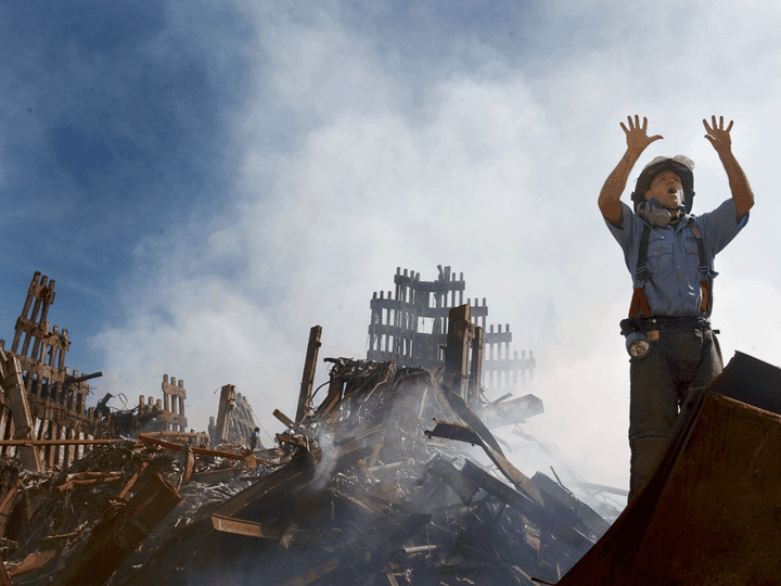  A New York City fireman calls for 10 more rescue workers to make their way into the rubble of the World Trade Center on September 14, 2001 days after the 9/11 terrorist attack.