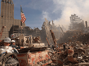 Firefighters and search-and-rescue workers battle smoldering fires as they search for survivors at the ruins of the World Trade Center in New York following the Sept. 11, 2001 attacks.