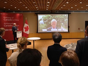 A screen shows Canadian Ambassador Dominic Barton delivering a statement from Dandong, via video link at the Canadian Embassy in Beijing, on Aug. 11, after Canadian businessman Michael Spavor was sentenced to 11 years in prison.