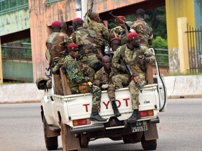 Members of the Armed Forces of Guinea drive through the central neighbourhood of Kaloum in Conakry on Sept. 5, 2021 after gunfire was heard.