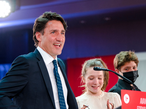 Canadian Prime Minister Justin Trudeau, flanked by children Ella-Grace and Xavier, delivers his victory speech after general elections at the Queen Elizabeth Hotel in Montreal, Quebec, early on September 21, 2021.