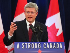 Prime Minister Stephen Harper speaks to the media, after approving the acquisition of Nexen Inc. by CNOOC, in 2012.